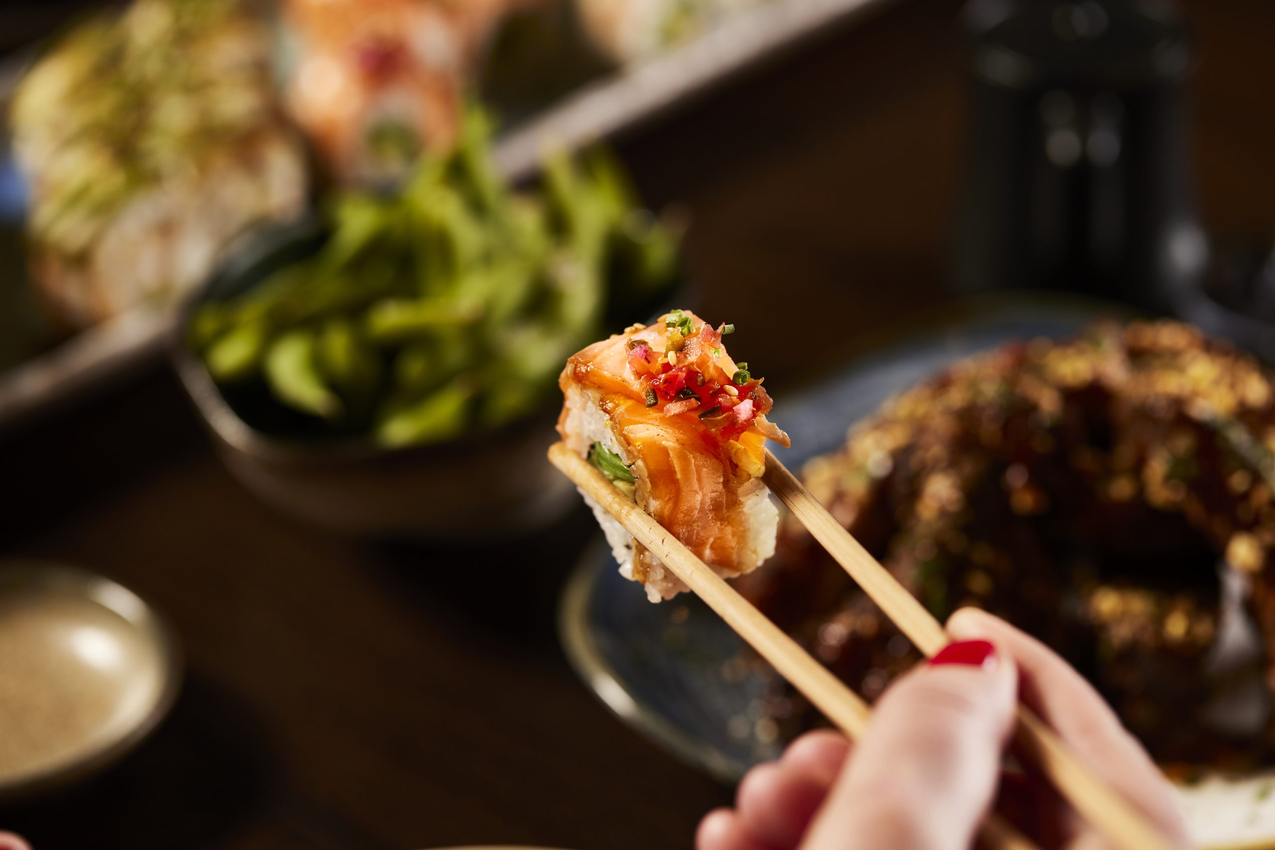 Exquisite sushi selection with chopsticks.